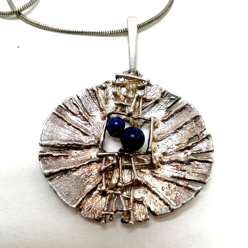 159 - Brutalist style pendant set with lapis lazuli (4cm across) on a silver marked chain (44cm) - SOLD ON... 