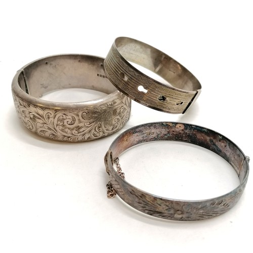 220 - 3 x silver marked bangles - 98g ~ large engraved bangle has dents to back - SOLD ON BEHALF OF THE NE... 