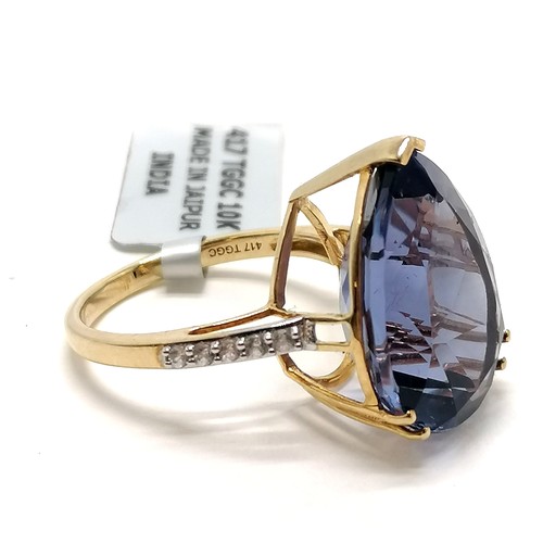 249 - 9ct hallmarked gold large pear shaped blue stone ring with white stone set shoulders - size Q & 6.2g... 