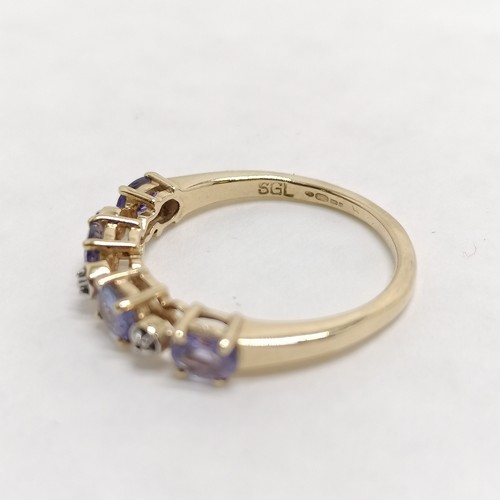 268 - 14ct hallmarked gold tanzanite / white stone set ring - size L & 2.1g total weight