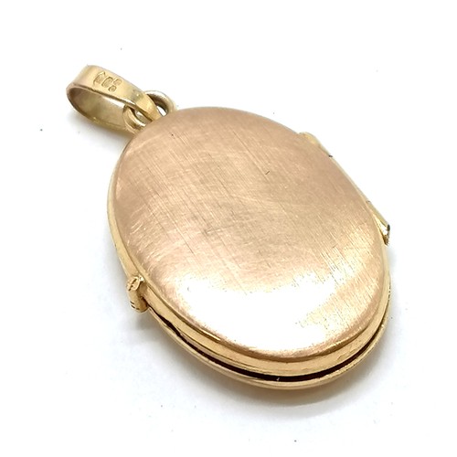 307 - 9ct hallmarked gold locket with engraved front - 2.5cm drop & 1.8g total weight