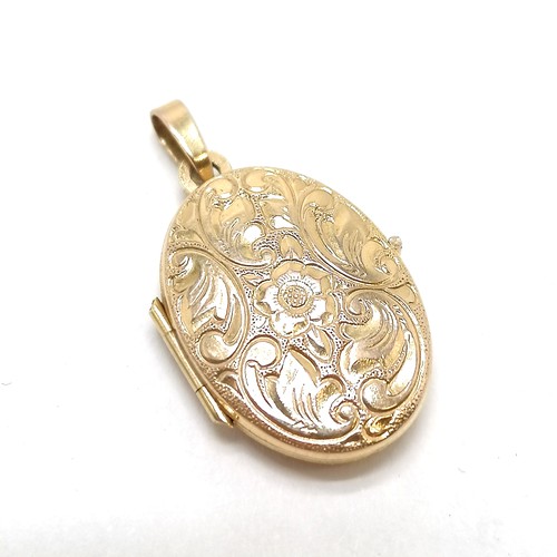 307 - 9ct hallmarked gold locket with engraved front - 2.5cm drop & 1.8g total weight