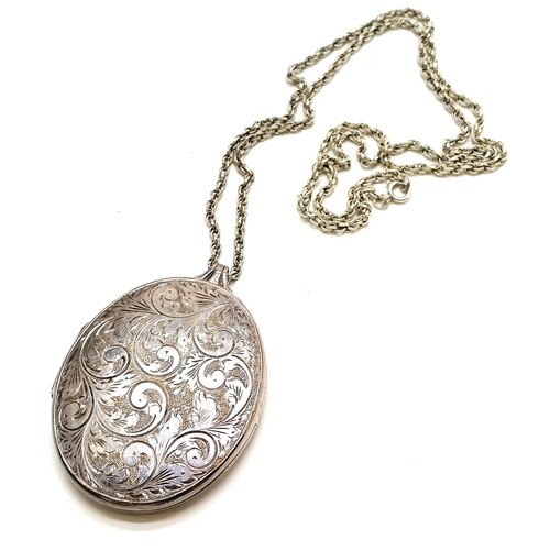 311 - Large engraved silver locket (6cm drop) on silver 56cm chain ~ total weight 38g