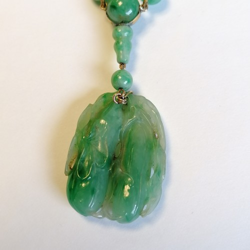 234 - Antique Chinese spinach jade bead (largest bead 10mm in diameter) necklace with a hand carved pendan... 