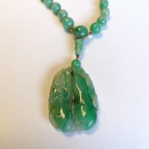 234 - Antique Chinese spinach jade bead (largest bead 10mm in diameter) necklace with a hand carved pendan... 