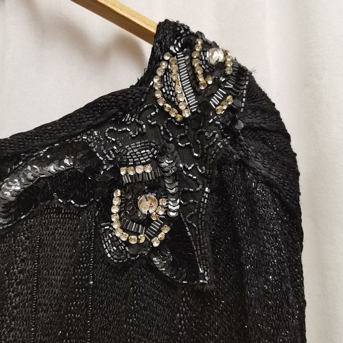 72 - 1980s black knitted dress with bead work to shoulder, chest 82cm.