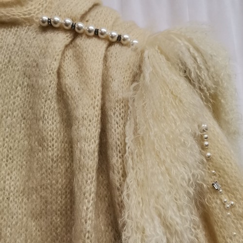 77 - 1980s knitted cream coat with pearl trimmed shoulders and sleeves and sheepskin trim, diamantes acro... 