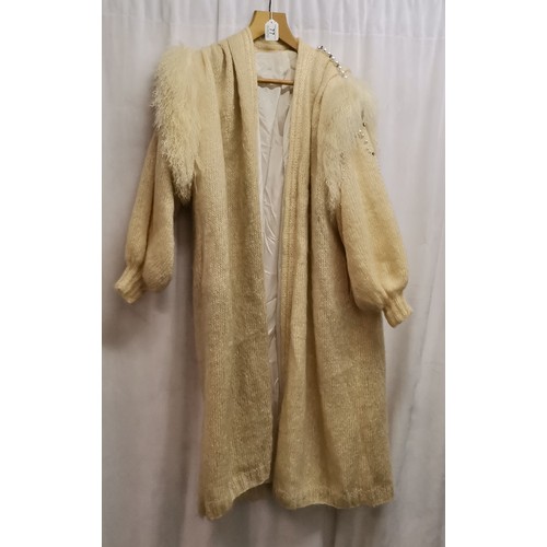 77 - 1980s knitted cream coat with pearl trimmed shoulders and sleeves and sheepskin trim, diamantes acro... 