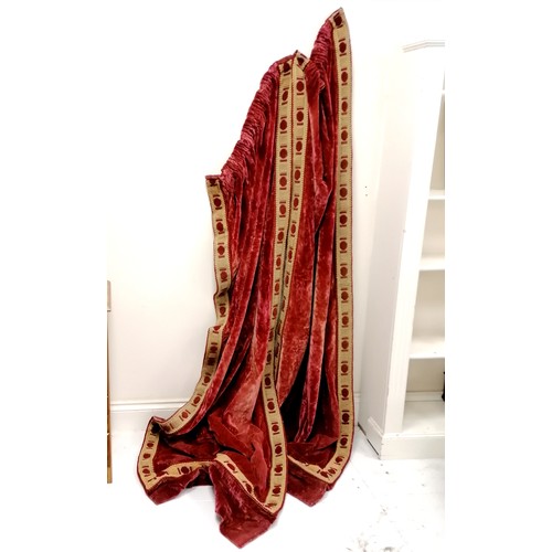 29 - Pair of antique red velvet curtains with embroidered panel detail to edging - each curtain 70cm wide... 