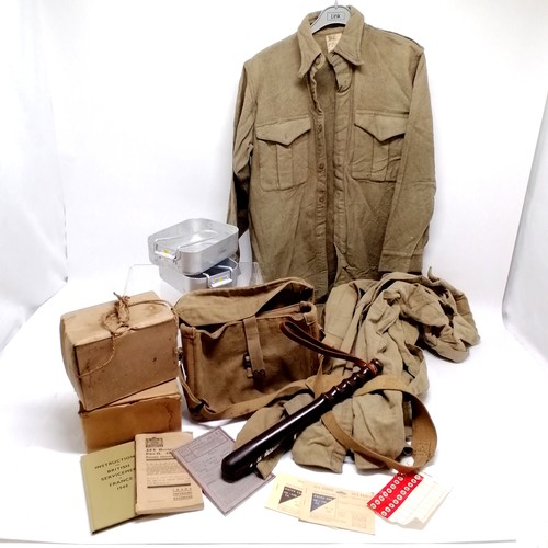 38 - 1943 dated British military bag, 3 khaki shirts (a/f), 2 gas masks, wooden truncheon, booklets, mess... 