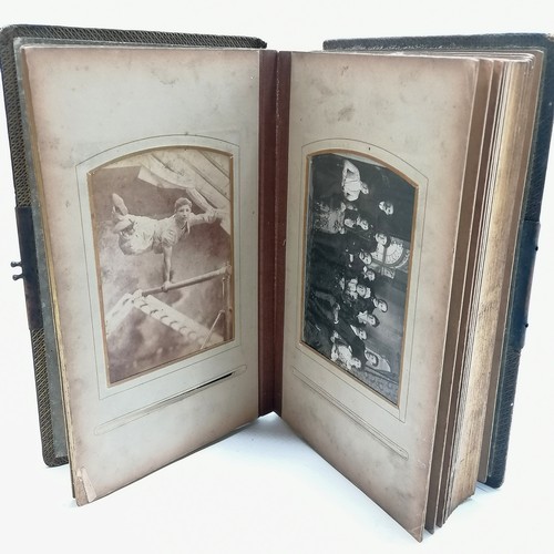 48 - Antique album containing qty of cabinet cards inc gymnast