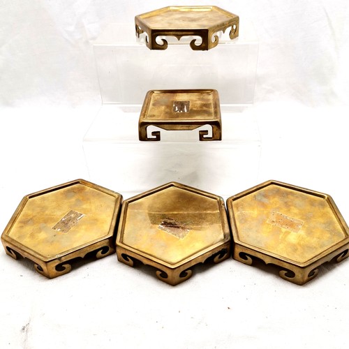 163 - An assortment of brass oriental vase stands, 4 x hexagonal 11.5 cm diameter and a square stand, 9.5 ... 