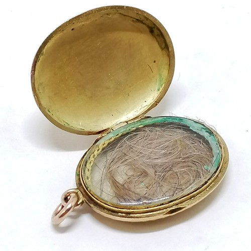 203 - Antique unmarked gold (touch tests as 14ct) locket with blue enamel cross detail and hand chasing - ... 