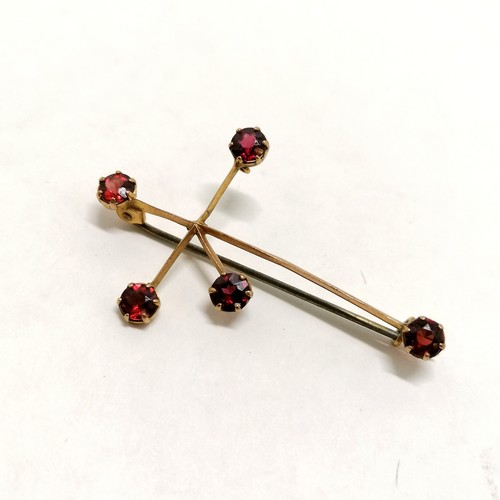 241 - 2 x 9ct marked gold brooches (1 set with garnet) - both with metal pins (total weight 3.5g) t/w gold... 