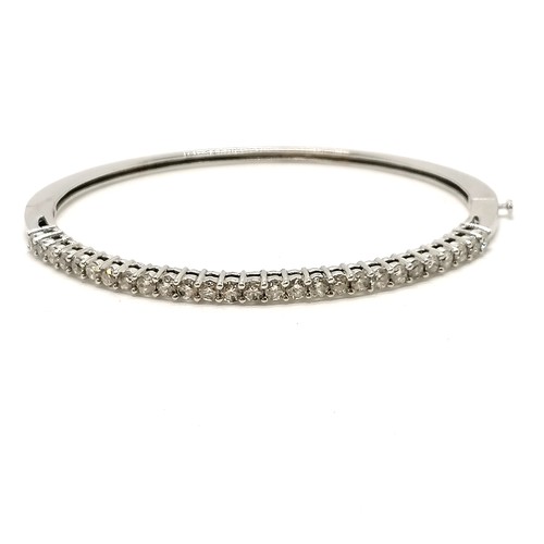 300 - 14ct marked white gold bangle set with 27 diamonds (approx 2.4mm diameter) - 6.5cm across x 5.5cm de... 