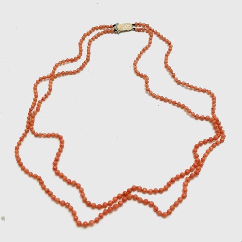 345 - Double strand of coral beads (46cm) with a 9ct gold marked clasp