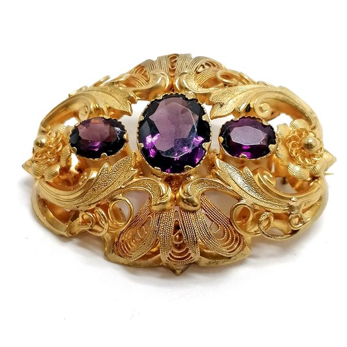 354 - Victorian antique filigree brooch set with purple stones - 4.5cm across