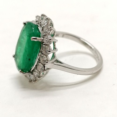 356 - 18ct marked white gold emerald (approx 15mm x 10.5mm) & diamond cluster ring - size N½ &  5.9g total... 