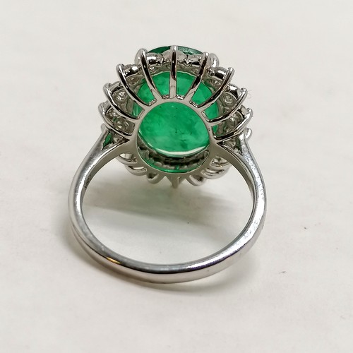 356 - 18ct marked white gold emerald (approx 15mm x 10.5mm) & diamond cluster ring - size N½ &  5.9g total... 