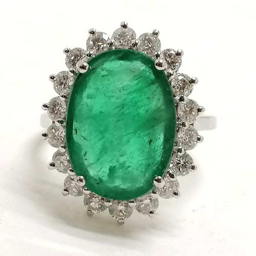 356 - 18ct marked white gold emerald (approx 15mm x 10.5mm) & diamond cluster ring - size N½ &  5.9g total... 