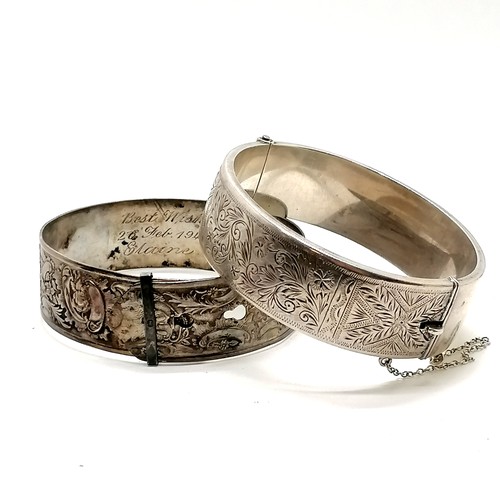 359 - 2 x silver bangles - 68g total weight (the half engraved bangle with slight dents is wax filled - th... 