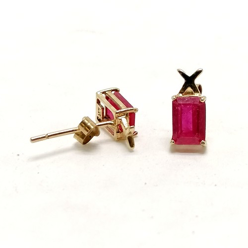 378 - 9ct marked gold ruby earrings - 0.9g total weight - rubies approx 6mm x 4mm