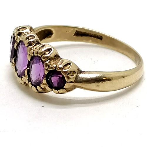 384 - 9ct hallmarked gold ring set with 5 amethysts - size N½ & 2.1g total weight ~ middle stone 'loose'