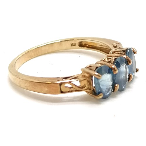 389 - 9ct hallmarked gold 3 stone sapphire ring with pierced decorated boxed shoulders - size N½ & 2.3g to... 