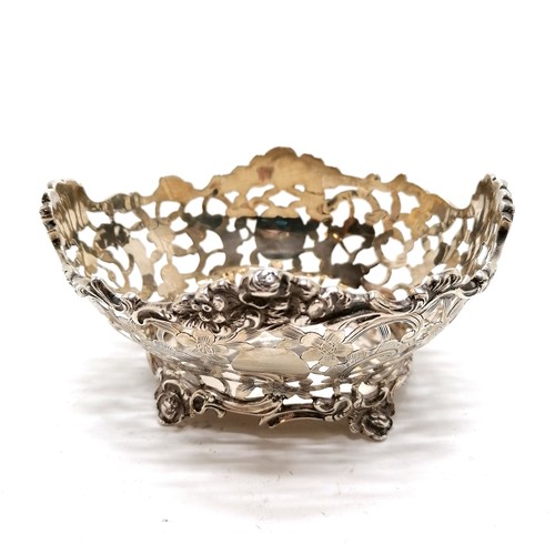 453 - 1901 sterling silver pierced bon-bon dish with chased decoration on 4 feet by Solomon Joel Phillips ... 