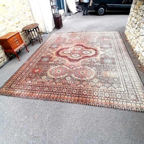 662 - Large antique pink, blue and black wool rug 345 cm wide. Has wear and a small hole to 1 corner