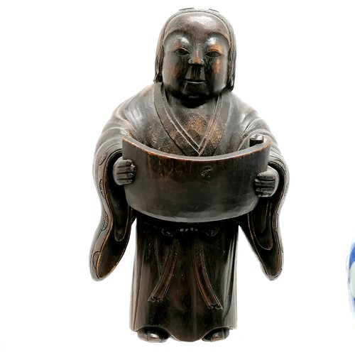 21 - 2 Oriental blue and white plates, both A/F, carved wooden figure holding a scroll25cm high, blue and... 