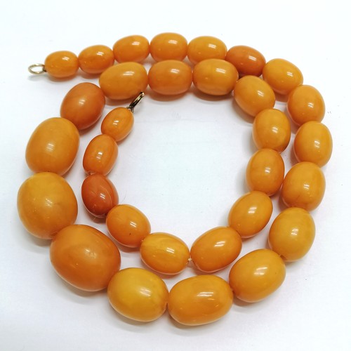 188 - Antique strand of butterscotch amber beads 60cm long & 76g total weight