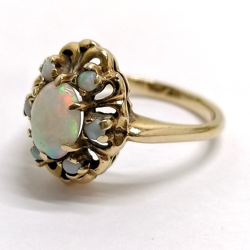 189 - Unmarked gold opal cluster ring - size R½ & 3.7g total weight. Has chip to centre stone