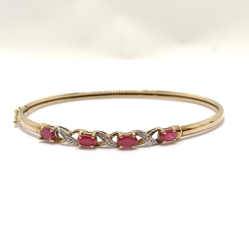 233 - 9ct marked gold bangle set with rubies & diamonds - 4.1g & 6cm across - SOLD ON BEHALF OF THE NEW BR... 