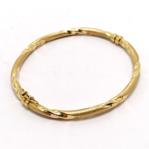 289 - 9ct marked gold bangle - 7cm across & total weight 5.2g