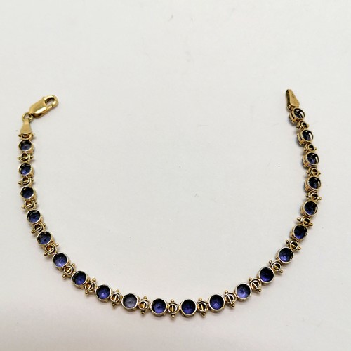 294 - 10ct marked gold purple stone (tanzanite?) bracelet - 17cm & 4.5g total weight