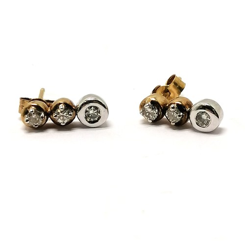 295 - Pair of unmarked gold earrings set with 3 diamonds each - drop approx 1cm & 1.8g total weight