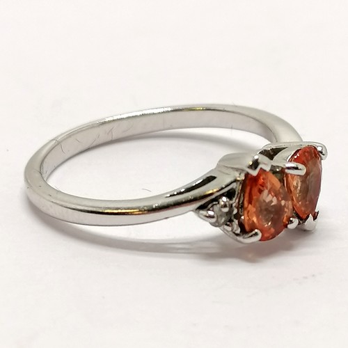 306 - 9ct hallmarked white gold pear shaped orange sapphire 2 stone ring - size N½ & 2.6g total weight