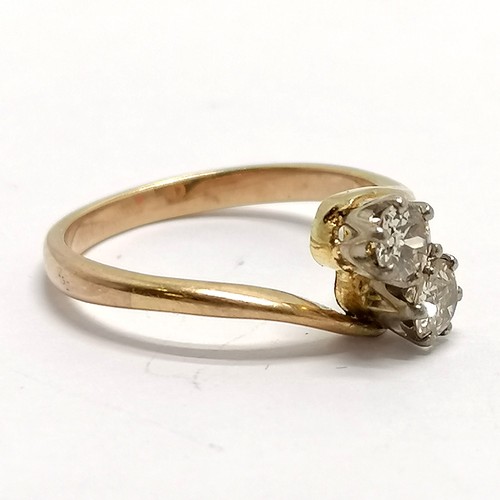 361 - Unmarked gold (tests as higher than 9ct) 2 stone diamond crossover ring - size N & 2.7g total weight... 