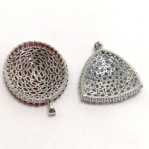 373 - 2 large silver multi stone set (ruby & tanzanite?) pendants - oval is 5cm drop ~ 27g total weight