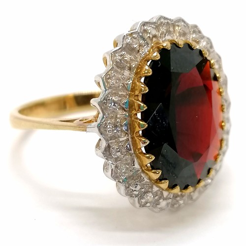 413 - 9ct hallmarked gold large garnet (approx 14.5mm long) & diamond set ring - size P & 4.5g total weigh... 