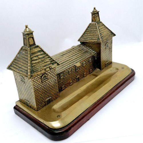 68 - Antique brass desk stand in the form of a chateau, with 2 inkwells and a stamps box. Mounted on a ma... 