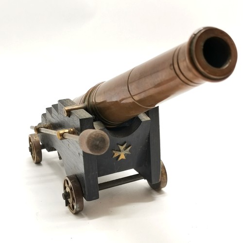 74 - Bronze cast model of an antique cannon on wooden limber with maltese cross decoration and has ramrod... 