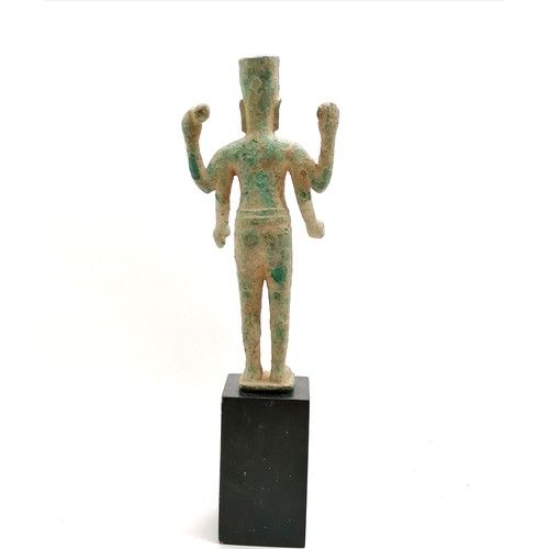 89 - South east asian bronze deity figure on a black wood base - total height 46cm