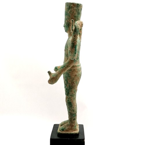 89 - South east asian bronze deity figure on a black wood base - total height 46cm