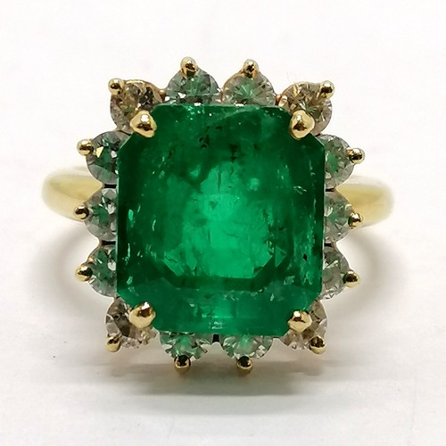 103 - 18ct marked gold emerald & diamond cluster ring - size M½ & 7.1g total weight ~ the emerald is appro... 