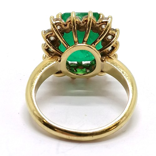 103 - 18ct marked gold emerald & diamond cluster ring - size M½ & 7.1g total weight ~ the emerald is appro... 