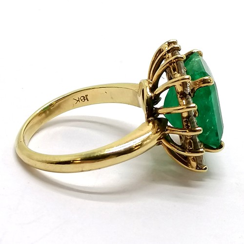 103 - 18ct marked gold emerald & diamond cluster ring - size M½ & 7.1g total weight ~ the emerald is appro... 