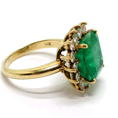 103 - 18ct marked gold emerald & diamond cluster ring - size M½ & 7.1g total weight ~ the emerald is appro... 