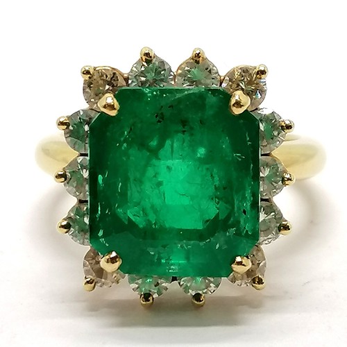 103 - 18ct marked gold emerald & diamond cluster ring - size M½ & 7.1g total weight ~ the emerald is appro... 